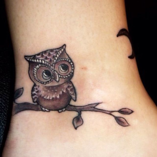 owl tattoo on branch