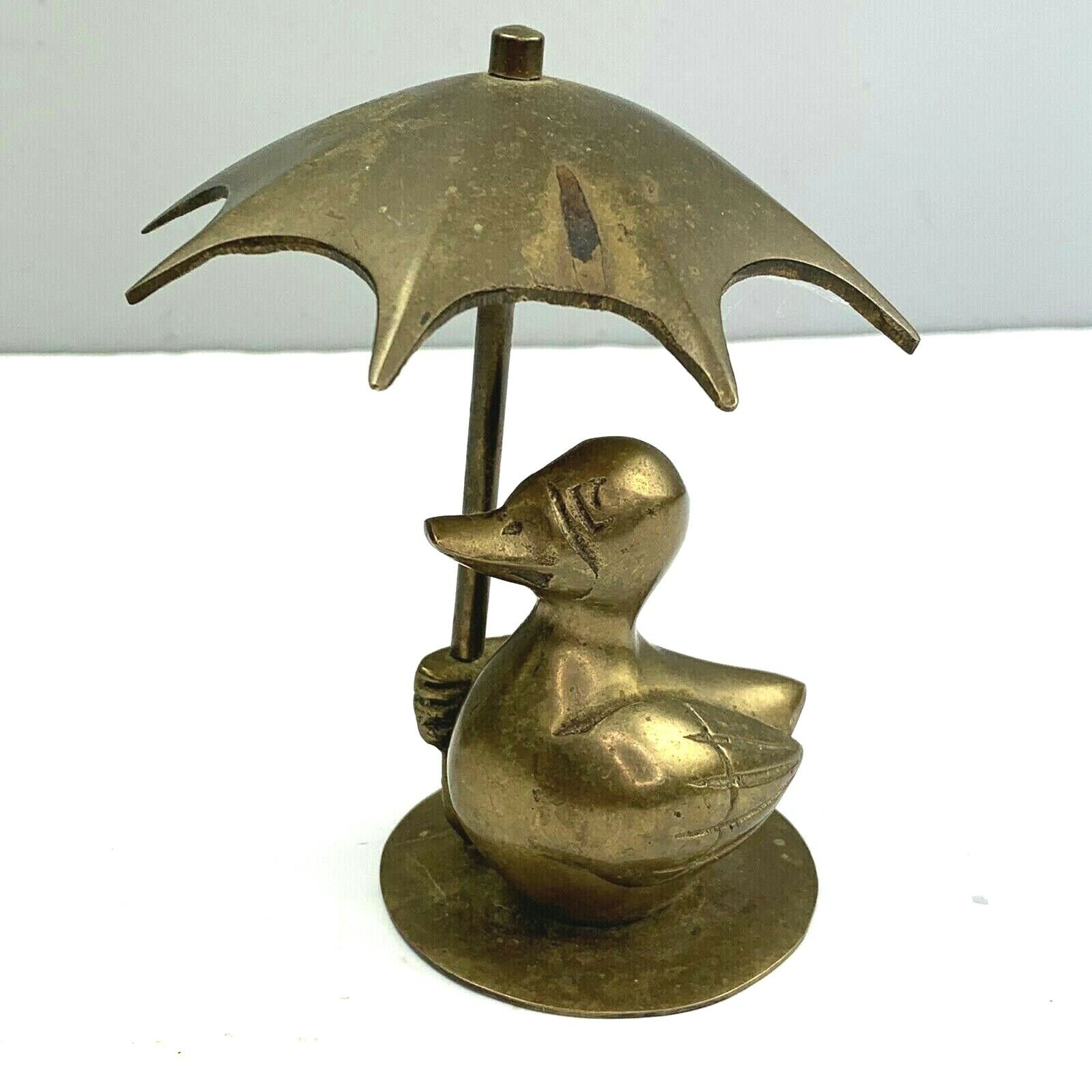 brass duck with umbrella